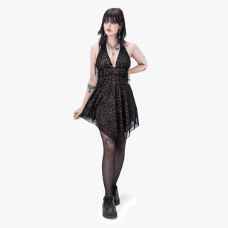 Woman wearing a black leopard print dress on a white background