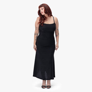 Model wearing the Nocturna Midi Dress by Wicked Misfit in large, showcasing the front of the dress. 
