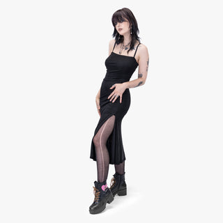 Model wearing the Nocturna Midi Dress by Wicked Misfit, showcasing the dress's slit 